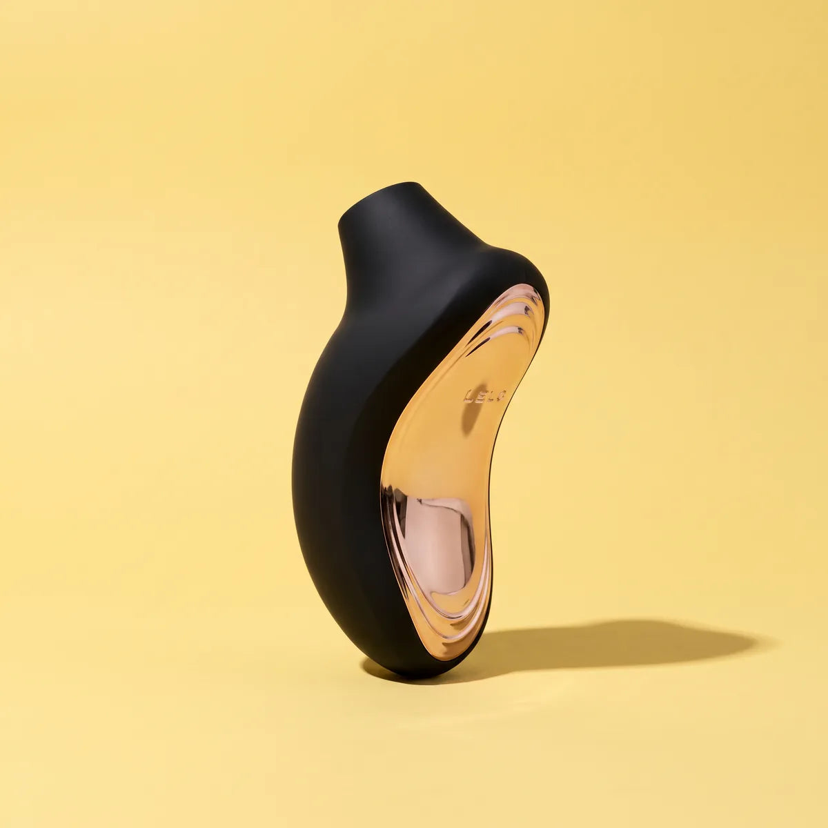 SONA 2 CRUISE personal massager in black on a yellow backdrop